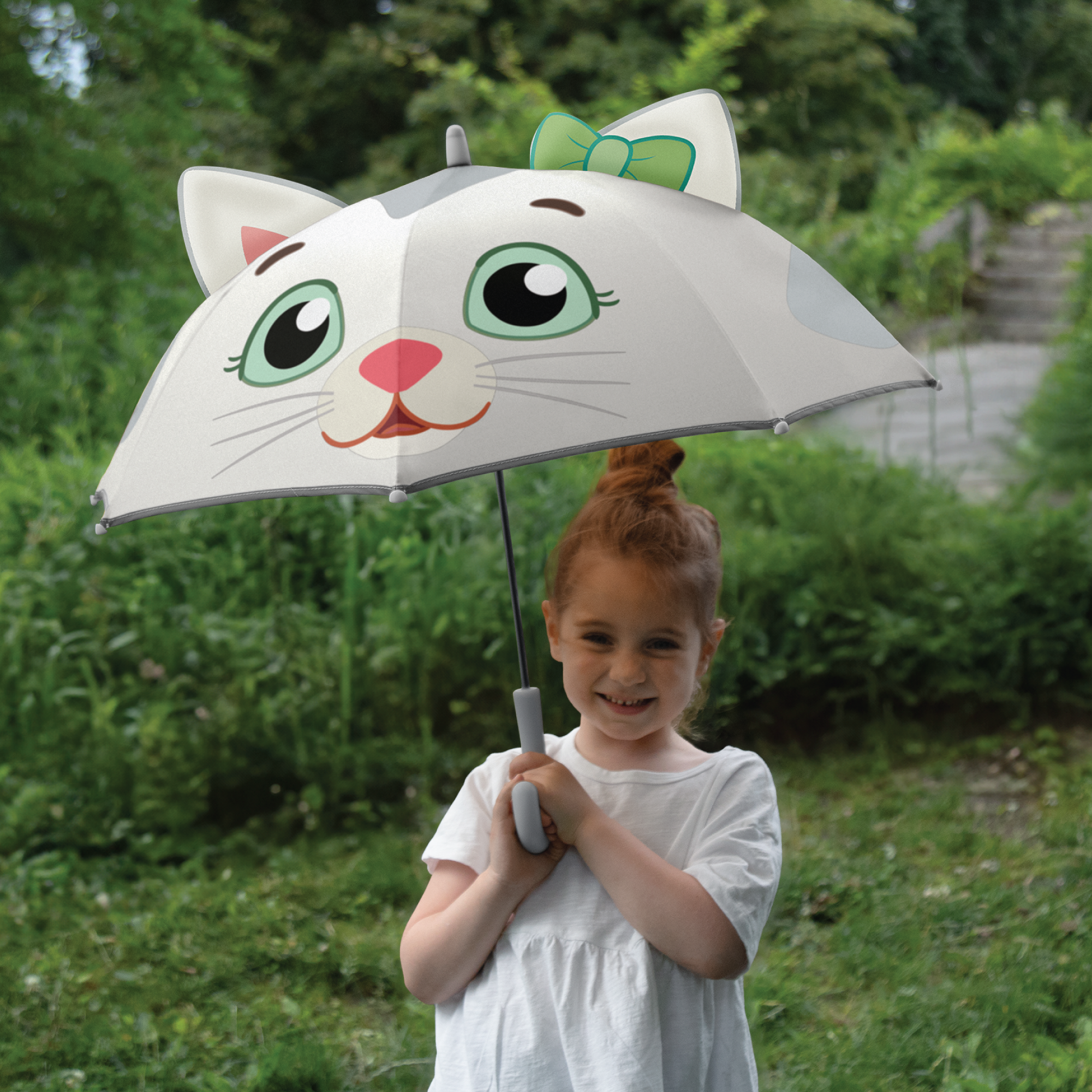 Young child smiling with Daniel Tiger's Neighborhood Katerina Kittycat Kids Umbrella.