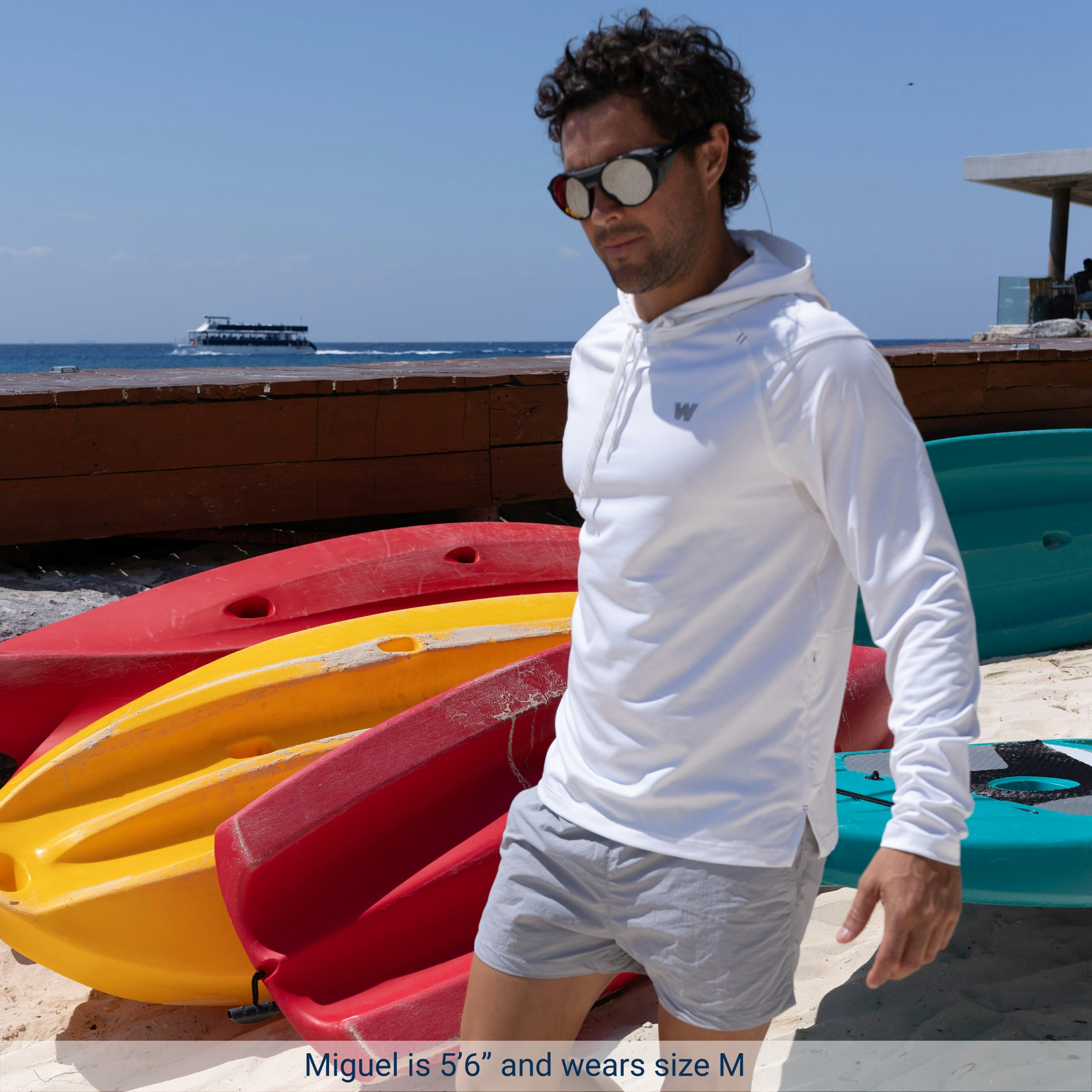 Man holding kayak wearing White Weatherman Sun Shirt in size medium.